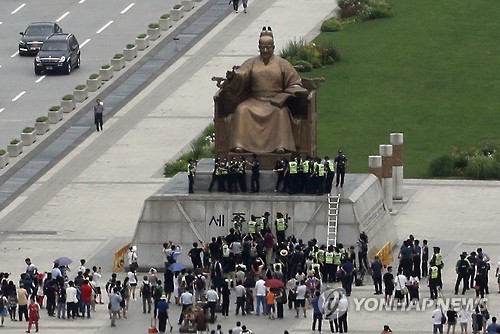 알바노조원들 세종대왕상에 올라 기습시위…최저임금 인상 요구