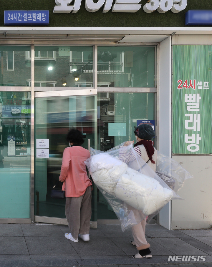 24시 셀프 빨래방 들어가는 이용객들