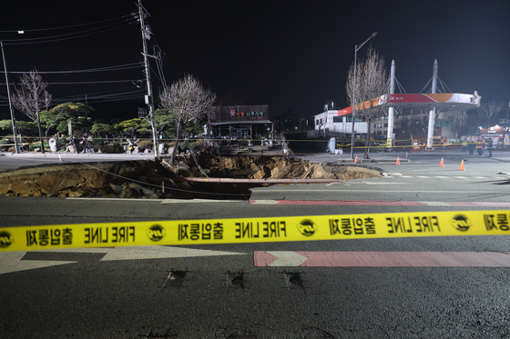 Sinkhole in Seouls Gangdong District traps SUV and motorcycle, injures one